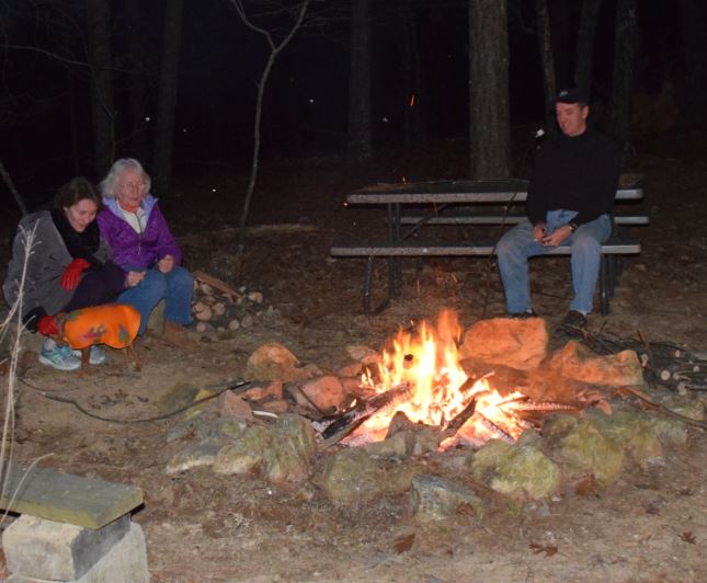 Group sitting around campfire in Ouachita Mountains